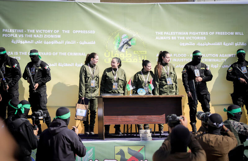 Al-Qassam Brigades, the military wing of Hamas, hand over four Israeli hostages to the Red Cross in Palestine Square, in Gaza City. Photo by Khalil Kahlout/Flash90