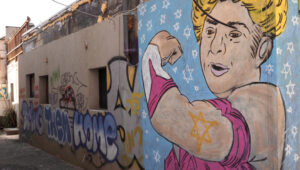 Rachel Edry as “Wonder Woman” in the Tel Aviv district of Florentin. Photo: Moshe Gruenbauer