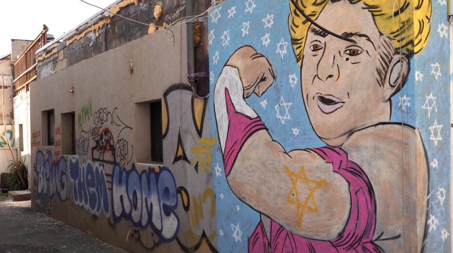 Rachel Edry as “Wonder Woman” in the Tel Aviv district of Florentin. Photo: Moshe Gruenbauer
