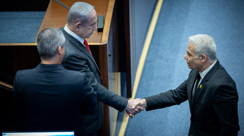 Israeli Prime Minister Benjamin Netanyahu shake hands with Opposition Leader Yair Lapid at a plenum session for Israeli Knesset's 75th birthday, in the assembly hall of the Knesset, the Israeli parliament in Jerusalem, Israel on Jan, 24, 2024. Photo by Yonatan Sindel/Flash90.