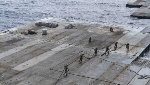 US Army soldiers assigned to the 7th Transportation Brigade (Expeditionary) handle line to secure the roll-on, roll-off distribution facility—or floating pier—to the side of the MV Roy P. Benavidez, in support of operations off the coast of Gaza on May 1, 2024. Credit: US Navy Photo.