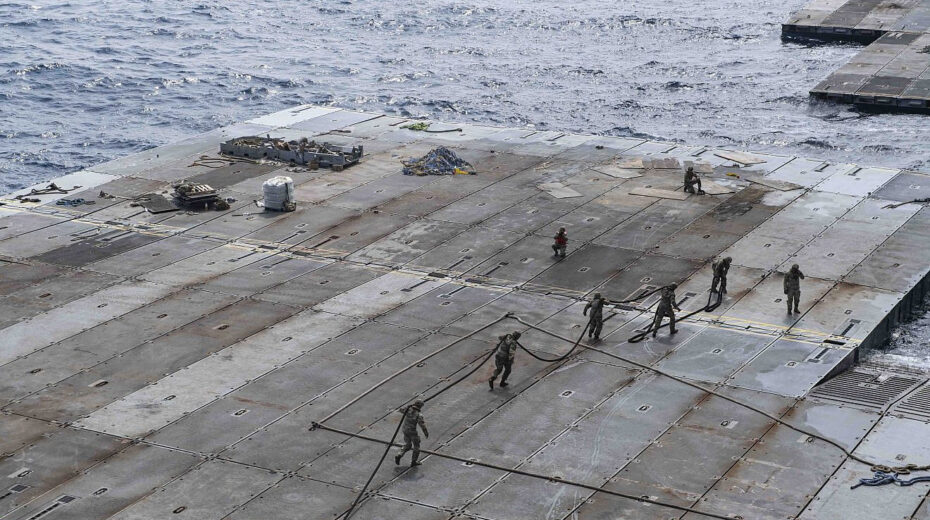 US Army soldiers assigned to the 7th Transportation Brigade (Expeditionary) handle line to secure the roll-on, roll-off distribution facility—or floating pier—to the side of the MV Roy P. Benavidez, in support of operations off the coast of Gaza on May 1, 2024. Credit: US Navy Photo.
