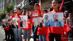 Palestinians holds pictures of Turkish strongman Recep Tayyip Erdogan as they wear shirts with Turkish flags in Hebron on July 20, 2016. Palestinians showed solidarity with Turky against the military coup which failed in toppling Erdogan's regime. Photo By Wisam Hashlamoun/FLASH90