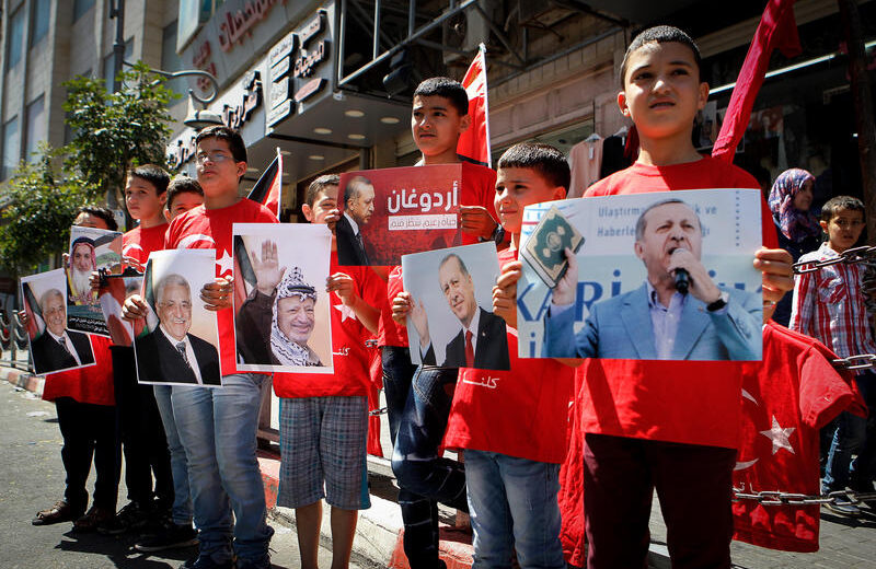Palestinians holds pictures of Turkish strongman Recep Tayyip Erdogan as they wear shirts with Turkish flags in Hebron on July 20, 2016. Palestinians showed solidarity with Turky against the military coup which failed in toppling Erdogan's regime. Photo By Wisam Hashlamoun/FLASH90
