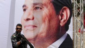 FRIEND OR FOE? Egyptian security guards stand near a banner showing President Abdel Fattah al-Sisi during a meeting between the Egyptian intelligence chief and Hamas officials in Gaza City, on May 31, 2021. Photo by Atia Mohammed/Flash90.