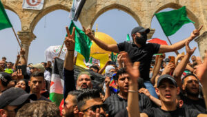 Palestinians wave Hamas flags outside the Al-Aqsa mosque on the Temple Mount in Jerusalem during the last Friday of Ramadan, April 29, 2022. Photo by Jamal Awad/Flash90.