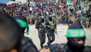 Al-Qassam Brigades, the military wing of Hamas, hand over four Israeli hostages to the Red Cross in Palestine Square, in Gaza City. Photo by Khalil Kahlout/Flash90