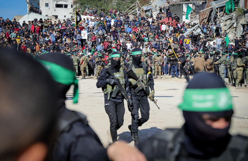 Al-Qassam Brigades, the military wing of Hamas, hand over four Israeli hostages to the Red Cross in Palestine Square, in Gaza City. Photo by Khalil Kahlout/Flash90