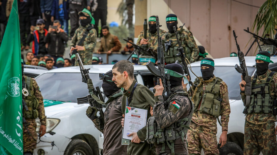 Well-fed Hamas terrorists hand over Israeli hostages to the Red Cross on February 8, 2025 in Deir al-Balah as part of the ceasefire agreement between Israel and Hamas. Photo: Abed Rahim Khatib/Flash90