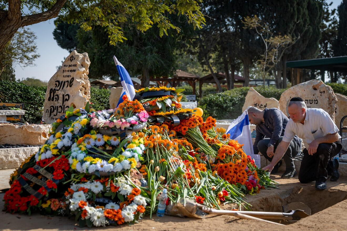 Mourners near the fresh grave of late Israeli hostages Shiri Bibas and her children Ariel and Kfir at the cemetery in Tzohar, southern Israel, Feb. 26, 2025. Photo by Chaim Goldberg/Flash90.