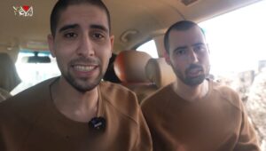 Hostages Guy Gilboa-Dalal and Evyatar David being forced to watch the ceremony of other captives being released in the Hamas propaganda video, Gaza Strip, Feb. 22, 2025. Source: X.