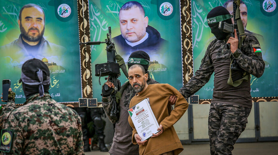Hamas's Al-Qassam Brigades parade Israeli captive Eli Sharabi in Deir al-Balah, the Gaza Strip, before handing him over to the International Red Cross, Feb 8, 2025. Photo by Abed Rahim Khatib/Flash90.