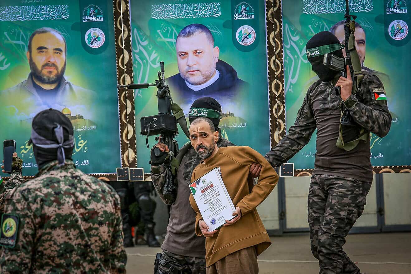 Hamas's Al-Qassam Brigades parade Israeli captive Eli Sharabi in Deir al-Balah, the Gaza Strip, before handing him over to the International Red Cross, Feb 8, 2025. Photo by Abed Rahim Khatib/Flash90.
