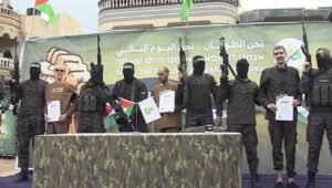 Three Israeli hostages are paraded by Hamas terrorists on a stage in the Gaza Strip before being handed over to the Red Cross, Feb. 8, 2025. Source: Screenshot/YouTube.