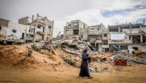 A Palestinian woman walks among wreckage in the city of Khan Yunis in the southern Gaza Strip. Photo by Abed Rahim Khatib/Flash90.