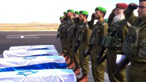 Israeli special forces receive the bodies of slain hostages Shiri Bibas, Ariel Bibas, Kfir Bibas, and Oded Lifshitz in the Gaza Strip. Photo: IDF Spokesperson