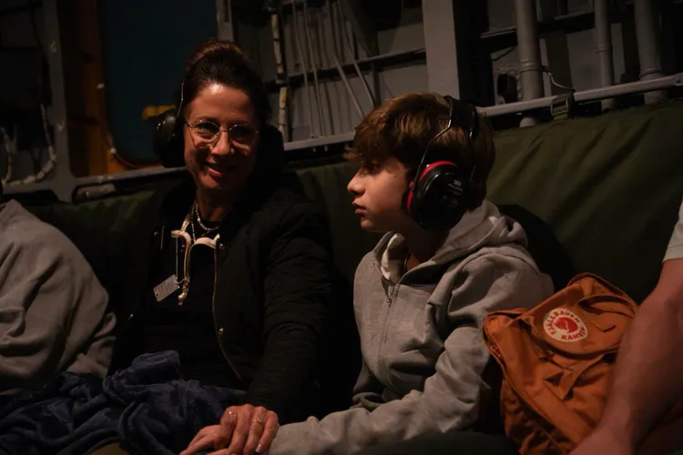 Yagil Yaakov with his mother, Renana, aboard an IDF helicopter after being released from Hamas captivity along with his older brother, Or, on November 27, 2023. Photo: IDF Spokesperson