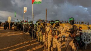 Al-Qassam Brigades terrorists and ordinary Gazans waiting for the handover of the bodies of four Israeli hostages to the Red Cross in Khan Yunis, Feb. 20, 2025. Photo by Abed Rahim Khatib/Flash90.