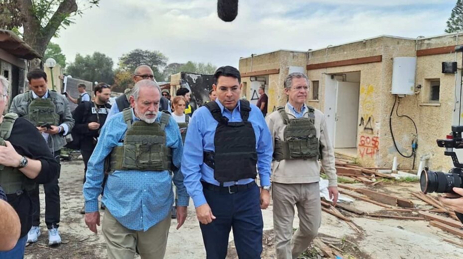 Former Arkansas Governor Mike Huckabee (left), MK Danny Danon (center) and former Kansas Governor Sam Brownback (right) at Kibbutz Kfar Aza, Dec. 20, 2023. Credit: Courtesy.