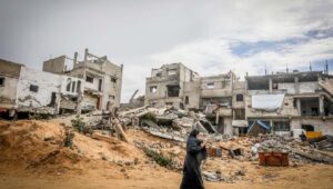 A Palestinian woman walks among wreckage in the city of Khan Yunis in the southern Gaza Strip. Photo by Abed Rahim Khatib/Flash90.