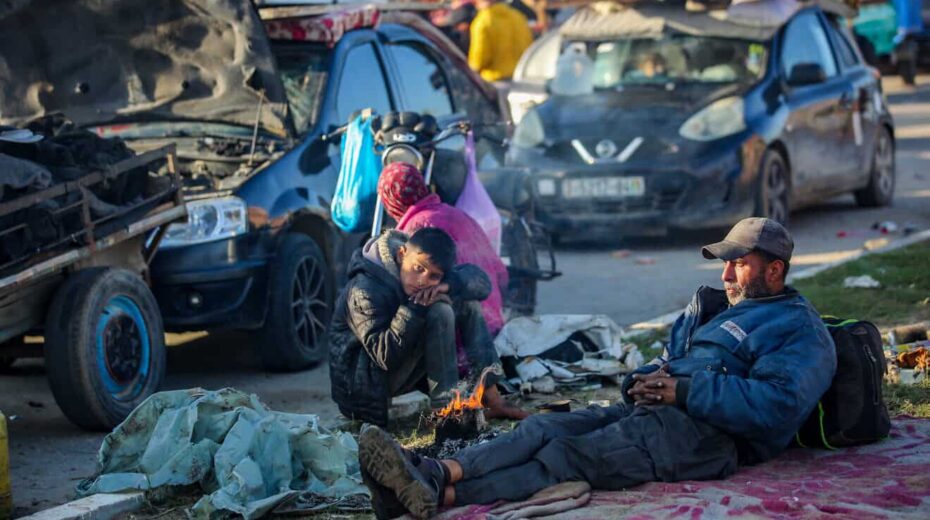Palestinians wait on Salah al-Din Road, the main highway of the Gaza Strip, not far from the Netzarim Corridor that separates the north of the Gaza Strip from the south, Jan. 26, 2025. Photo by Ali Hassan/Flash90.