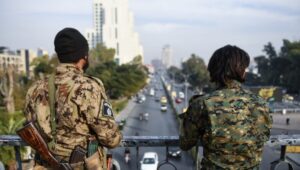 Two armed men monitor a street from a bridge in Damascus, Syria, on December 11, 2024. EPA-EFE/HASAN BELAL