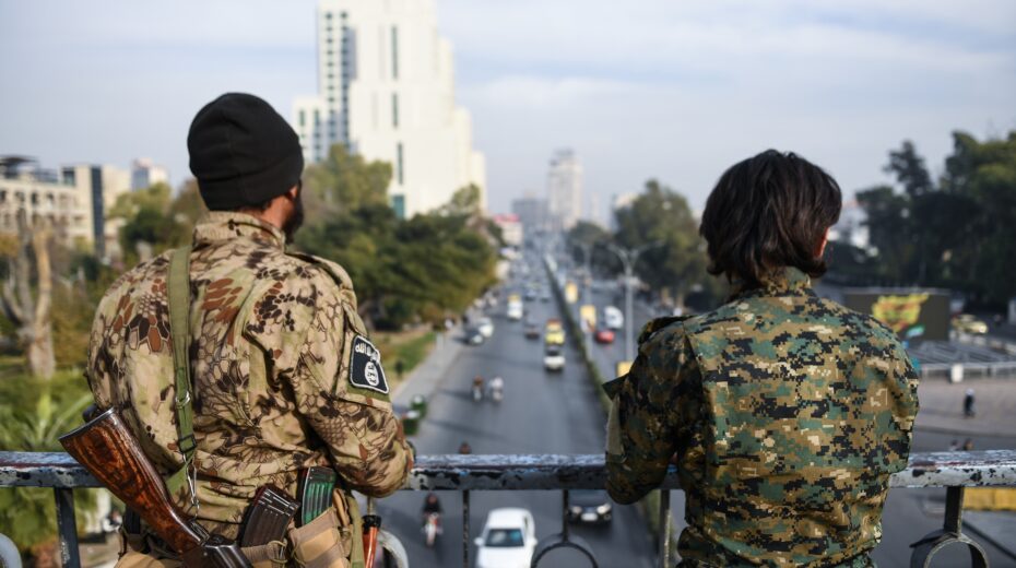 Two armed men monitor a street from a bridge in Damascus, Syria, on December 11, 2024. EPA-EFE/HASAN BELAL
