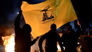 Hezbollah supporters carry a Hezbollah flag during a protest in front of the entrance to Rafic Hariri International Airport in Beirut, Lebanon, on February 13, 2025. Photo: EPA-EFE/WAEL HAMZEH