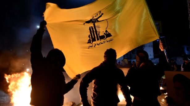 Hezbollah supporters carry a Hezbollah flag during a protest in front of the entrance to Rafic Hariri International Airport in Beirut, Lebanon, on February 13, 2025. Photo: EPA-EFE/WAEL HAMZEH