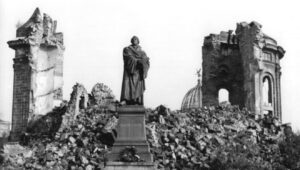 A statue of Protestant Reformation Martin Luther in the Ruins of Dresden, Germany, in the aftermath of World War II. Credit: Giso Löwe/German Federal Archives via Wikimedia Commons.