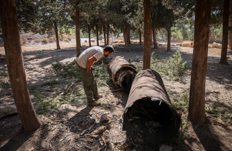 An Israeli examines the remains of a downed Iranian ballistic missile in a forest in northern Israel. Photo by David Cohen/Flash90