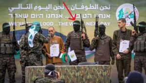 The Al-Qassam Brigades handed over Israeli hostages to the Red Cross in Deir al-Balah on February 8, 2025, as part of the ceasefire agreement between Israel and Hamas. The arrow marks the slain Nukhba terrorist. Photo: Abed Rahim Khatib/Flash90