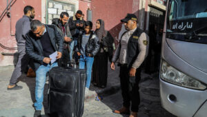 Palestinians wait to board a bus leaving the Gaza Strip during a ceasefire earlier this year. Photo by Abed Rahim Khatib/ Flash90