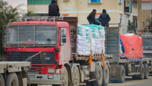 Palestinian trucks carrying humanitarian aid pass the Kerem Shalom border crossing east of the city of Rafah in the southern Gaza Strip on February 24, 2025, en route to Gaza. Photo: Ali Hassan/Flash90