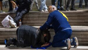 People take cover in Jerusalem as sirens warn of an incoming missile fired from Yemen, May 15, 2025. Photo by Oren Ben Hakoon/Flash90.