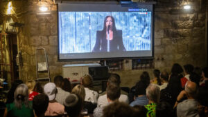 People watch the final of the 69th Eurovision Song Contest, at a pub in Jerusalem, on May 17, 2025. Photo by Cahim Goldberg/Flash90