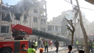Firefighters, rescue workers, and security personnel work around a building in central Tehran, Iran, following Israeli airstrikes on June 13, 2025. EPA-EFE/ABEDIN TAHERKENAREH