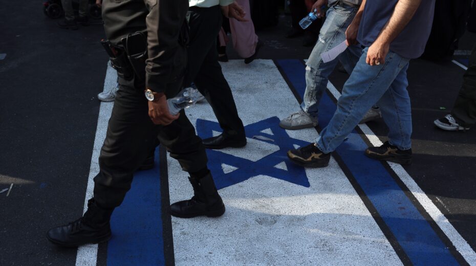 Iranians walk over an image of an Israeli flag during an anti-Israel rally in Tehran, Iran, on June 14, 2025. Photo: EPA-EFE/ABEDIN TAHERKENAREH