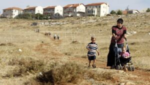 A woman and her children walk towards the town of Kochav HaShahar in the Binyamin region of Samaria, June 4, 2009. Photo by Abir Sultan /Flash90.