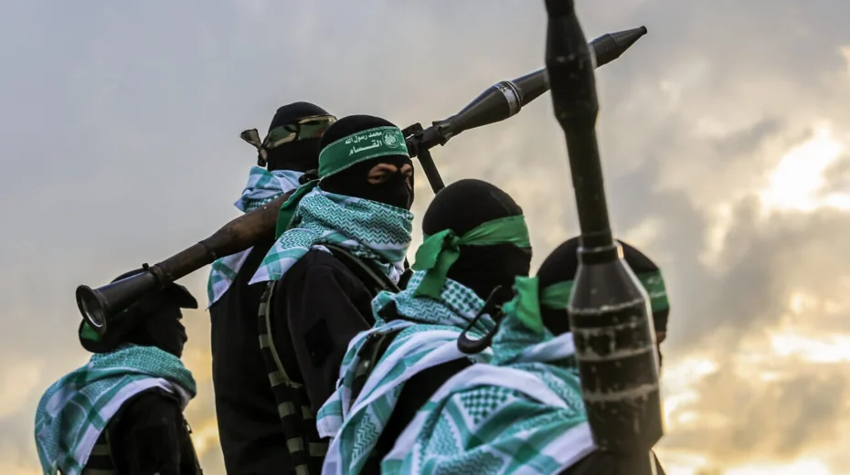 Terrorists in Gaza observe the transfer to Israel of four bodies of hostages murdered by Hamas, Feb. 20, 2025. Credit: Abed Rahim Khatib/Flash90.