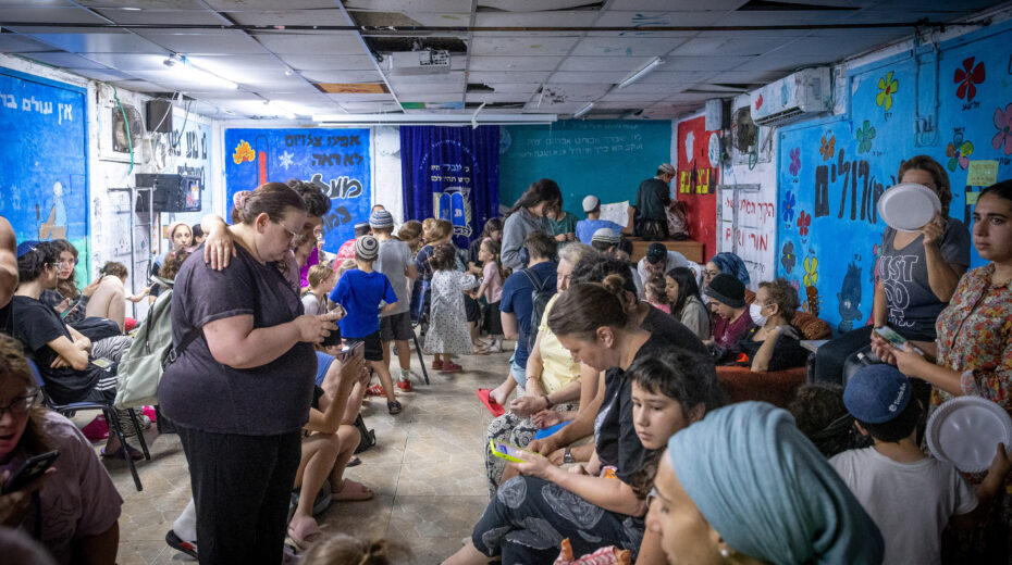 People take cover in a public shelter in Jerusalem after an alert was triggered warning of ballistic missiles fired from Iran toward Israel. June 23, 2025. Photo: Noam Revkin Fenton/FLASH90