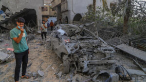 Palestinians at the site of an Israeli airstrike in the Sheikh Radwan neighborhood of Gaza City. Photo by Khalil Kahlout/Flash90