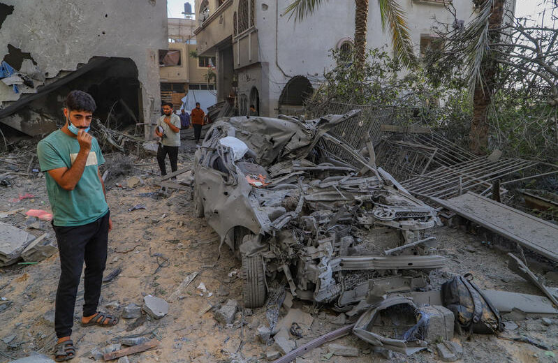 Palestinians at the site of an Israeli airstrike in the Sheikh Radwan neighborhood of Gaza City. Photo by Khalil Kahlout/Flash90