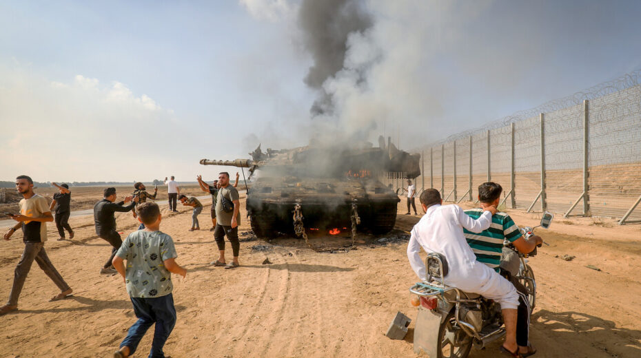 Palestinians take control of an Israeli tank after crossing the border fence with Israel from Khan Yunis in the southern Gaza Strip, October 7, 2023. Photo by Abed Rahim Khatib/Flash90