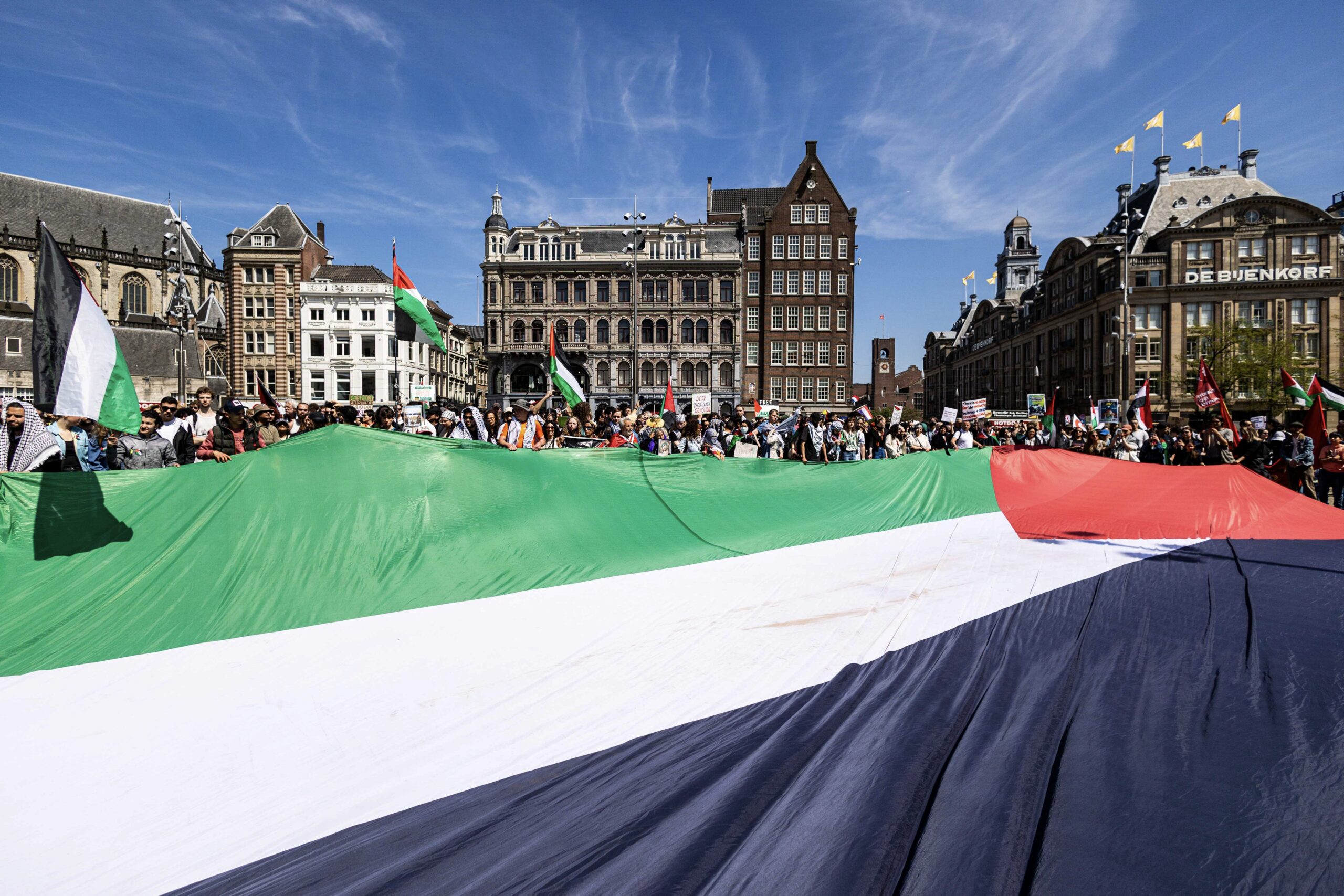 Anti-Israel demonstration on Dam Square in Amsterdam, Netherlands, on May 11, 2024: Participants hold a giant Palestinian flag during a pre-Nakba Day demonstration under the slogan "Stop the genocide in Gaza." Photo: EPA/Ramon van Flymen.