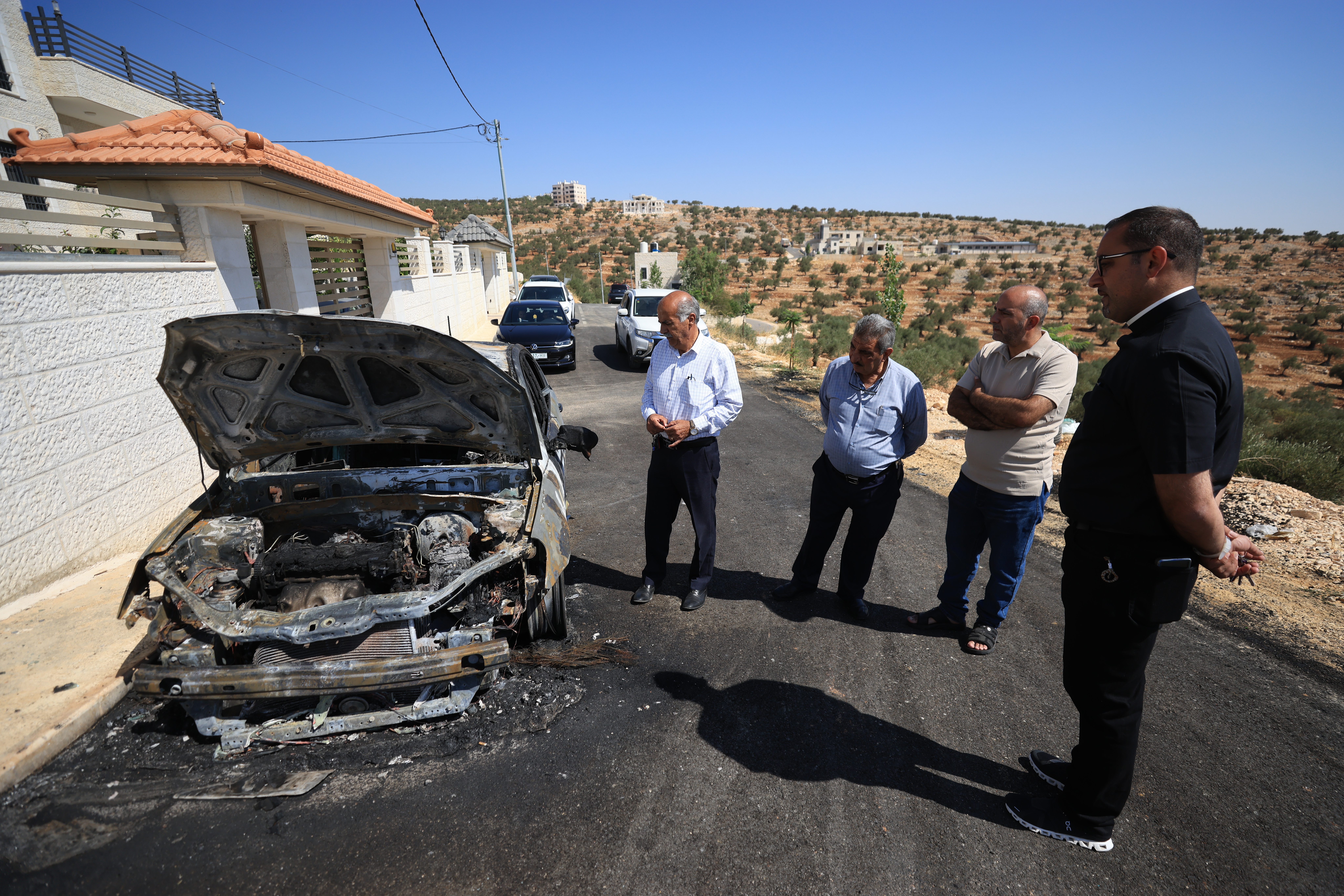 A burned car in Taybeh. Photo: EPA/ALAA BADARNEH