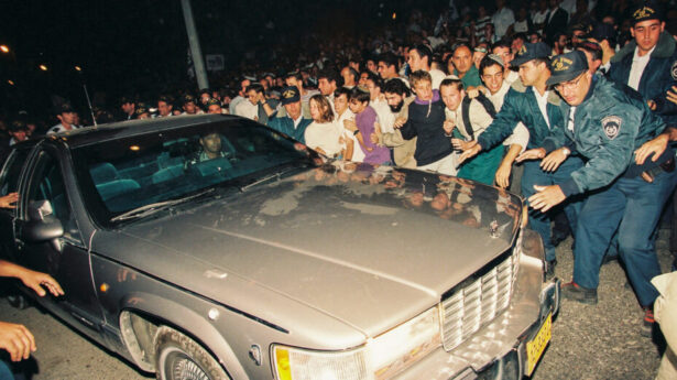 Israeli police attempt to prevent right-wing demonstrators protesting against the Oslo Accords from jumping onto Prime Minister Rabin's car, October 1995. Photo: Flash90