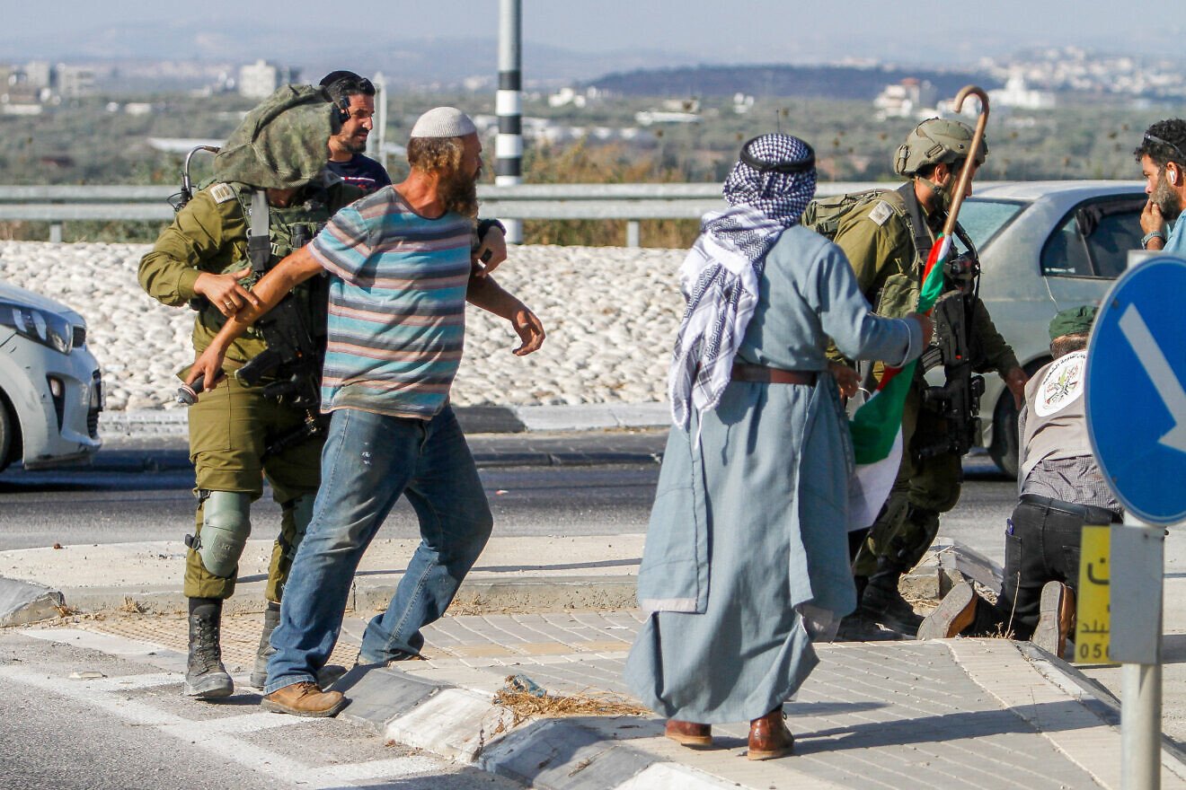 Palestinians confront a Jewish man during a protest against Israeli areas near Qalqilya, on Aug. 12, 2022. Photo by Nasser Ishtayeh/Flash90.