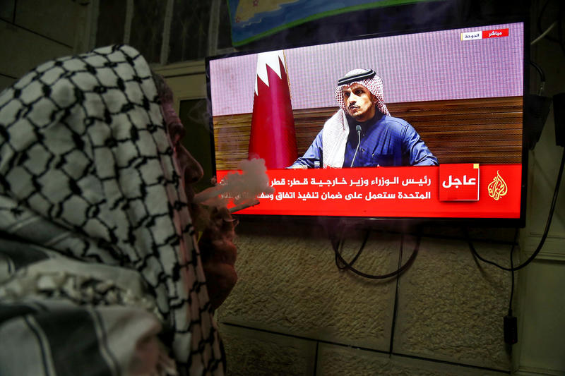 Palestinians watch a press conference of Qatar’s Prime Minister Sheikh Mohammed bin Abdulrahman bin Jassim Al Thani on the ceasefire deal between Israel and Hamas, in the West Bank city of Hebron, January 15, 2025. Photo by Wisam Hashlamoun/Flash90