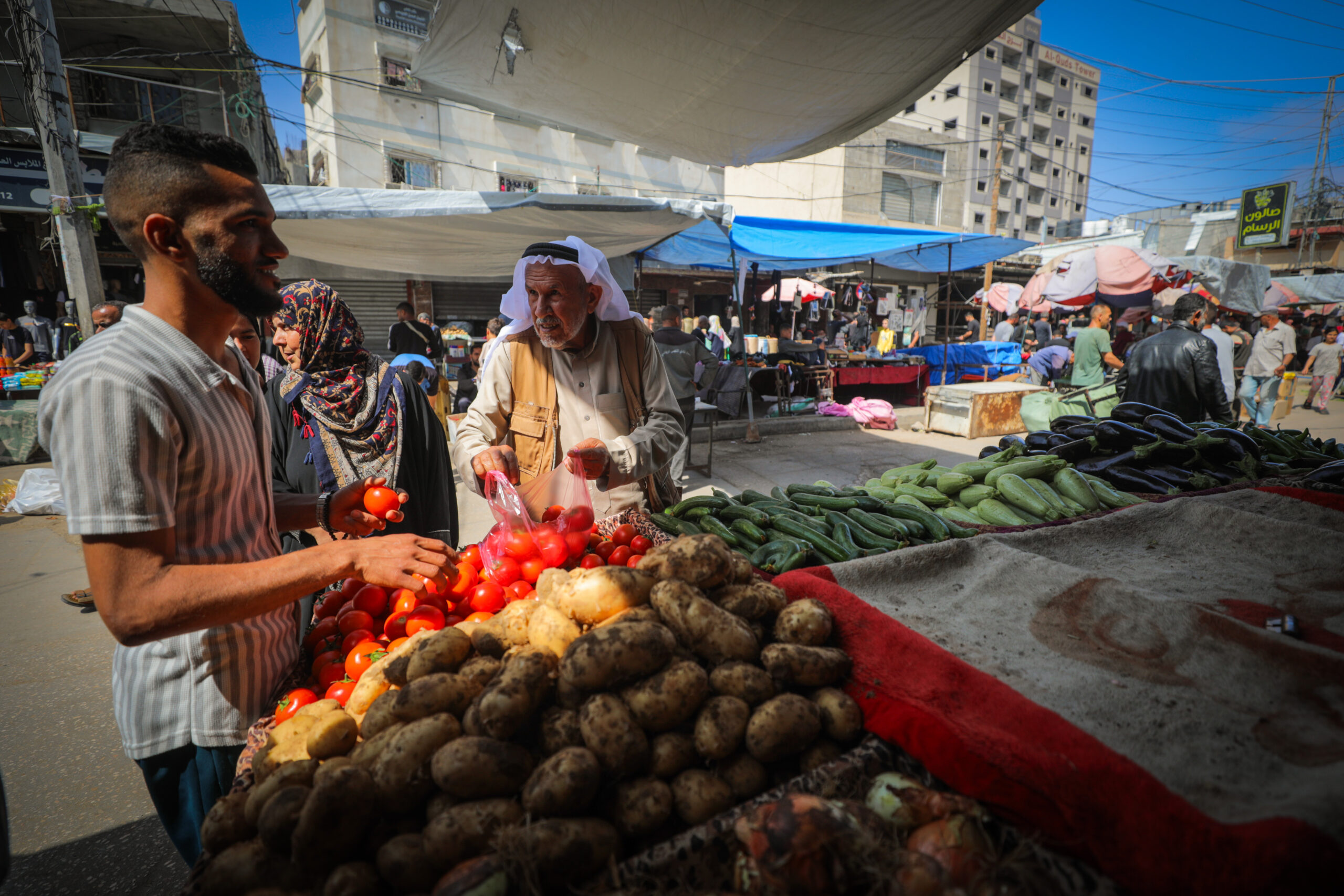 Palestinians shop at the market in the Nuseirat refugee camp in the central Gaza Strip, May 2025. Photo: Ali Hassan/Flash90